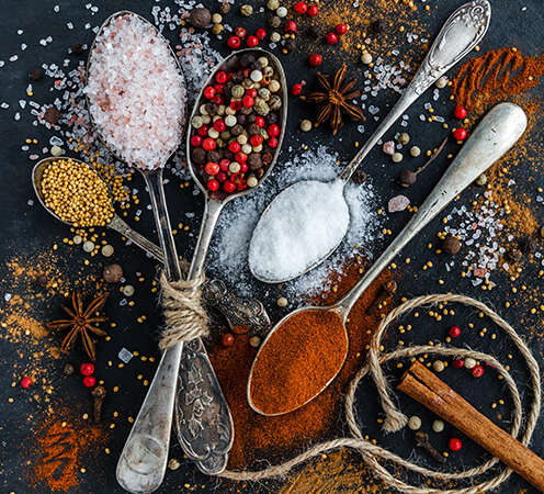 Seasoning carriers, anticaking agents, spices, fine grain salts